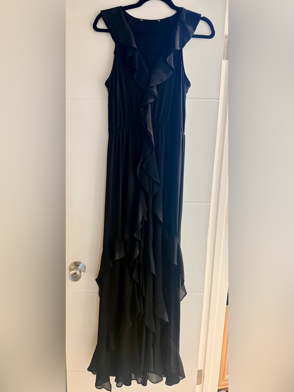 Black flowing dress, opened in the front from knee down, ruffles